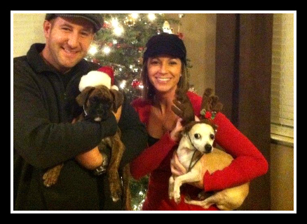 Mark and Carey holding dogs at Christmastime